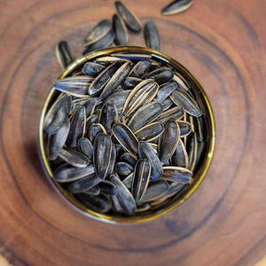 Sunflower Seeds in a Plate on a Wooden Board